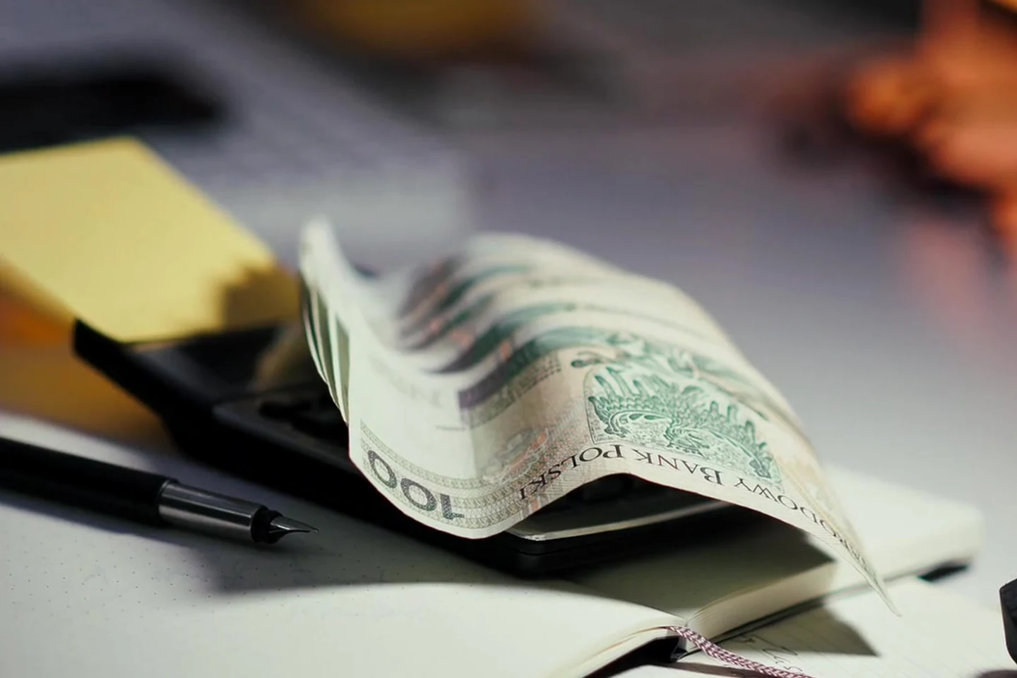 Cash on a desk beside study materials