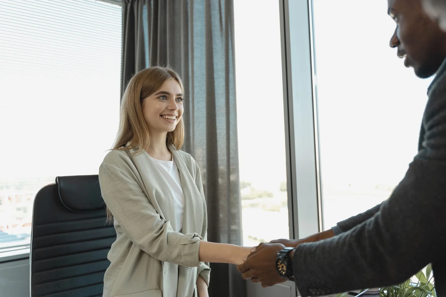 A graduate shaking hands during a professional meeting