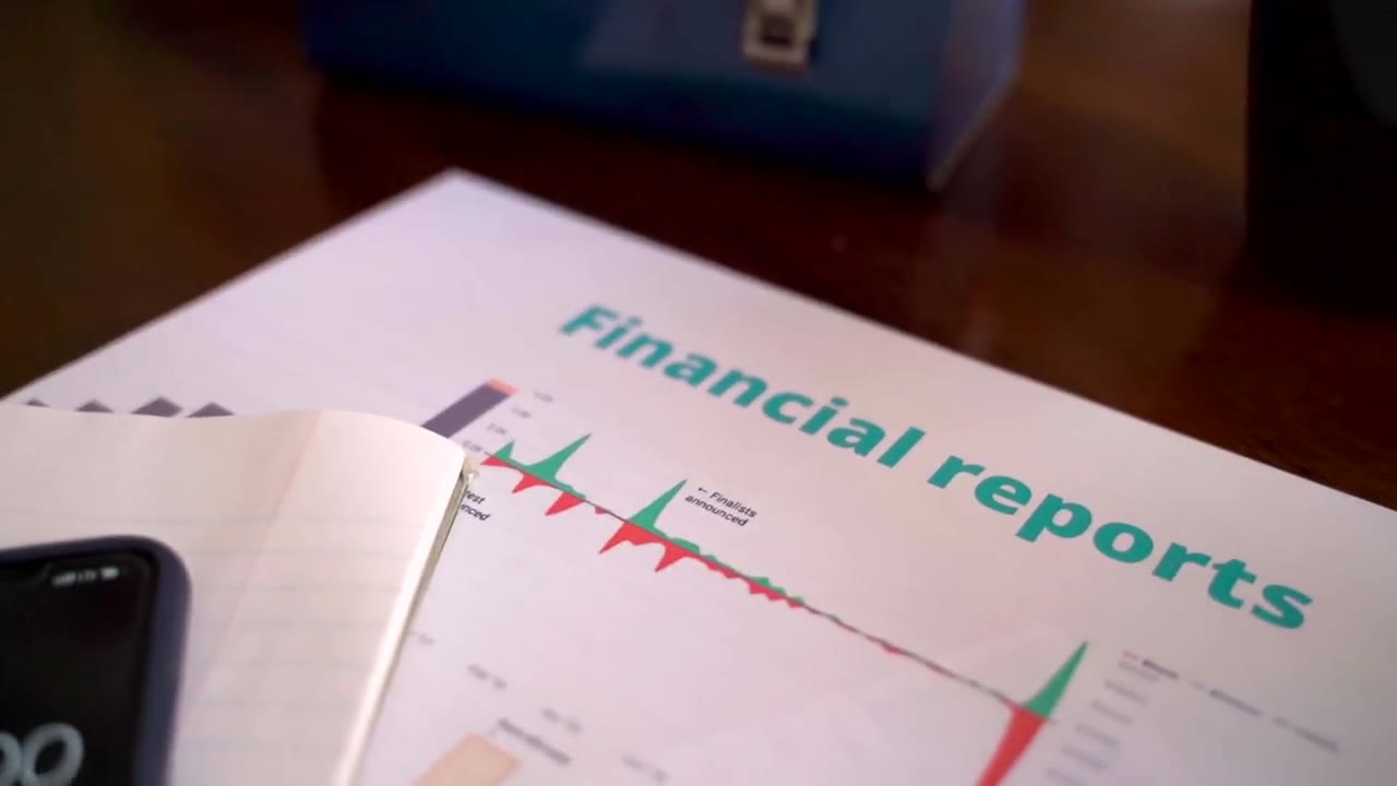 Financial reports and market data on screen