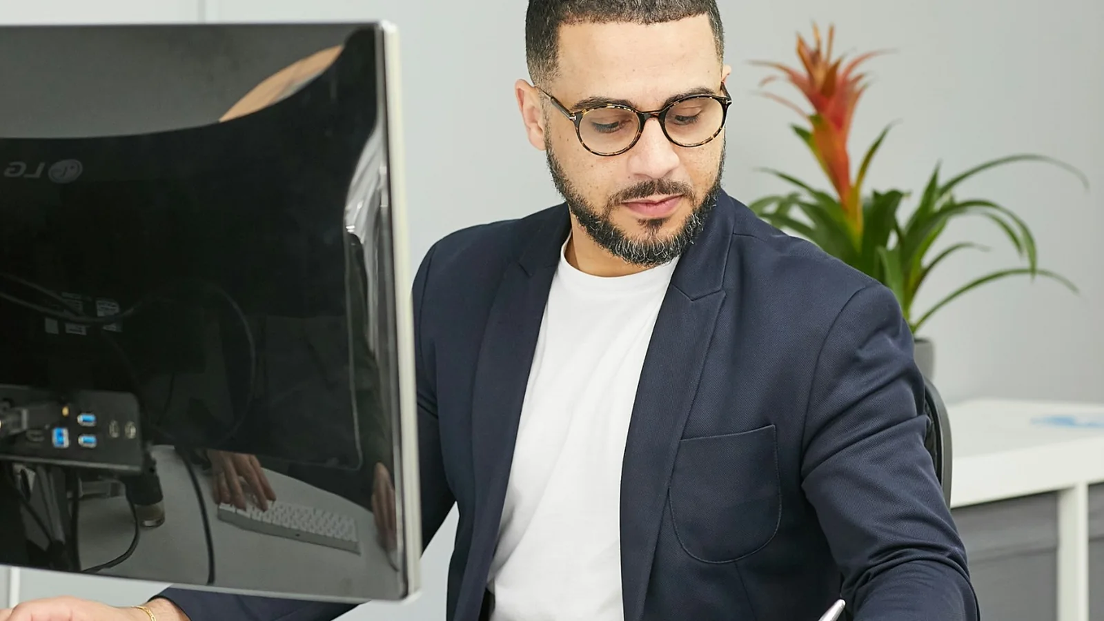 Professional reviewing investment research at a computer